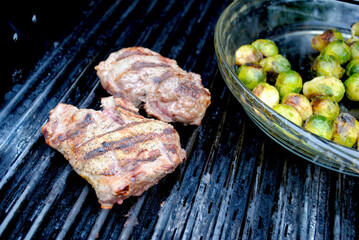 Two Beef Steaks Cooked on a Grill with Roasted Brussell Sprouts