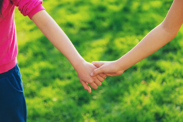 Fototapeta na wymiar Children walk together holding hands. Selective focus.