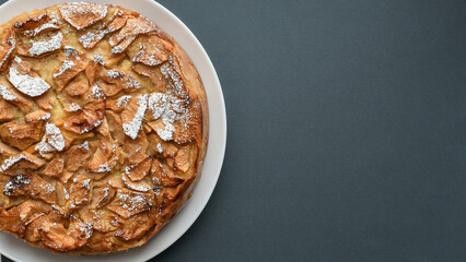 Top view of apple pie on grey background. Copy space. 