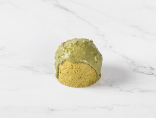 Green tea matcha cake with chocolate nut glaze. Light background