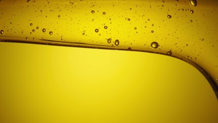 A stream of golden thick honey spills on a yellow background. Sweet honey molasses pours close up....