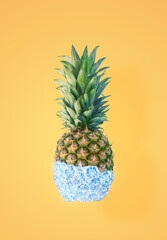 Creative yellow Summer tropical fruit concept of pastel tasty pineapple covered with ice. A refreshing healthy snack.