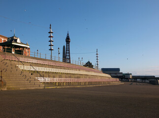 the pedestrian walkway near blackpool north pier with benches and shelter on the promenade