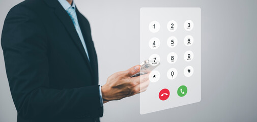 Dialing on virtual telephone keypad with transparent telephone buttons, businessman touch Emergency button of telephone number on screen, Finger touch number on smartphone to make a call, close up,