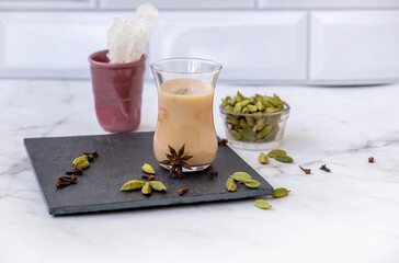 Traditional indian and middle eastern hot drink masala tea or karak chai with spice and milk. Exotic cuisine.