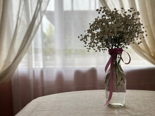 bouquet of gypsophila in a vase on the table. bridal bouquet. vintage flowers in the dark