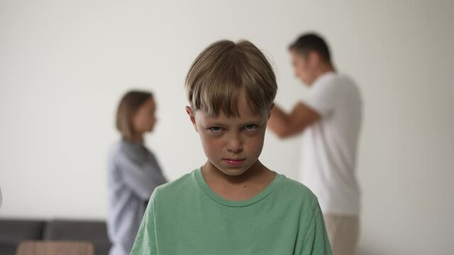 Kid son feels upset while parents fighting at background, sad little girl frustrated with psychological problem caused by mom and dad arguing, family conflicts or divorce impact on child concept