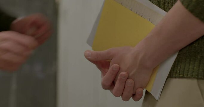 Hands pass documents to the interlocutor. Waiting for a meeting, finger movement nerves. They look at the documents, make a choice. The work of the secret police.