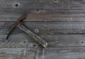 Vintage hammer on aged wooden floor