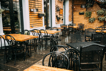 Tables, empty cafe during bad cold weather. nobody in Cafe. Free Tables, empty cafe during bad cold weather.