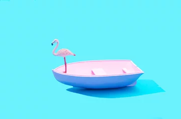 Fotobehang A pink flamingo standing on a pink boat against pastel blue background. Minimal surreal concept for summer holidays travel advertisement. Design for travel agency web banner or print © Miss V