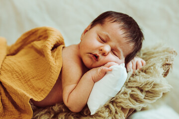 Cute baby sleeping on fur plaid