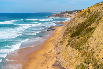 Aerial view of tropical sandy beach and ocean with turquoise water with waves. Sunny day on Atlantic ocean beach