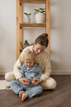 Happy woman playing with little son