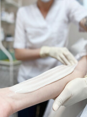 Hand depilation. Epilation with sugar wax. Sugaring, beauty salon. 