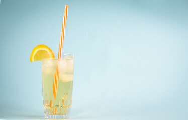 Aerial photo of a highball glass with ice tea filled with ice, lemon