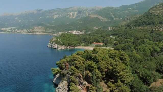 Montenegro. Adriatic Sea. Milocer beach. Summer. Sunny weather. High season. A very popular tourist spot. Drone. Flight. The camera moves forward