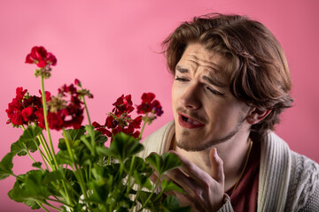 Mn with make up holding dry flowers