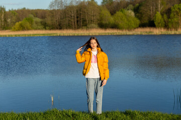 Portrait of stylish weared teenage girl outdoors in spring.