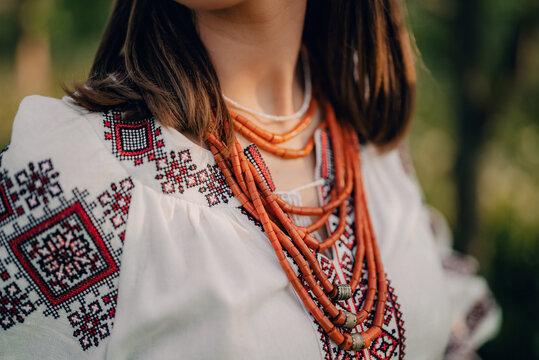 Ukrainian woman in embroidery vyshyvanka dress and ancient coral beads. Traditional antique jewelry necklace and costume of Ukraine.
