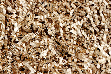 Close-up of corrugated cardboard paper pieces instead of bubble wrap in delivered parcel. Zero waste shopping delivery background texture.