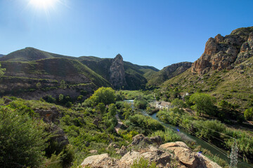 Landscape with green mountains and a small river in Spain.  Town of Gestalgar/Valencia.