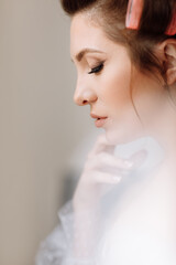 beauty concept. portrait of a beautiful young showy brunette woman with bright pin-up make-up in pink curlers. Studio Shot, Cropped. Facial treatment . Cosmetology , skin care and spa