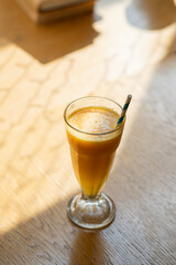 glass of orange juice on wooden table