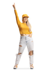 Full length portrait of a happy young female with a cap pointing up