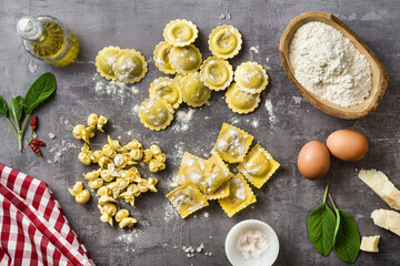 Fototapeta na wymiar different types of fresh raw italian ravioli on the table with cooking ingredients. home kitchen