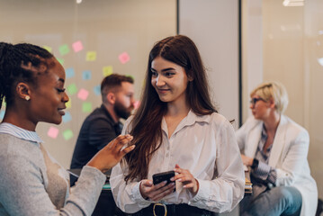 Two multiracial business colleagues working together in the office