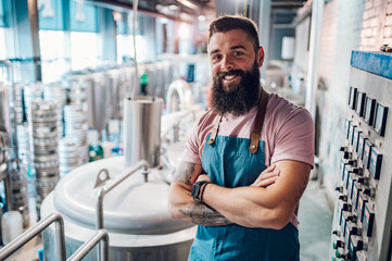 Portrait of a bearded man working in a brewery