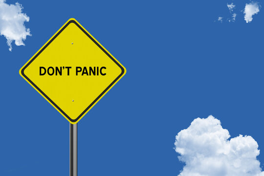 Don't Panic Sign On Sky Background.