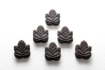 Delicious and exquisite chocolate cookies made with natural sweetener maple syrup in the shape of a traditional tree leaf from the culture of Canada
