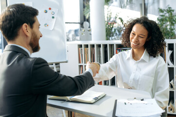 Smart successful African American woman was hired by the company. Two multiracial business...