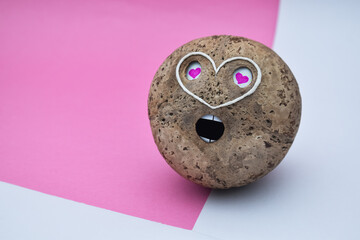 a coconut shell love emoji face object on white and pink background. Handmade design