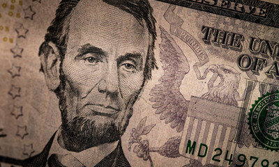 Close up of Abraham Lincoln's face on a $5 bill