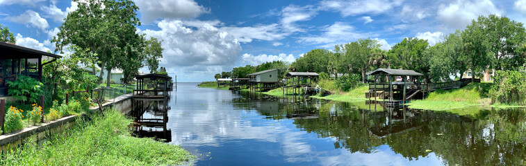 Fototapeta na wymiar Boat docks lining a canal leading to a freshwater lake in central Florida