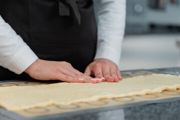 the chef forms a shape from the dough