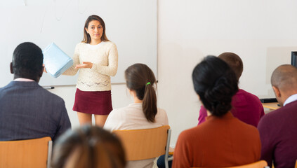 Fototapeta premium Businesswoman advertises a product in front of an audience