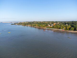 Naklejka na ściany i meble Charming seaside town with the look of a fishing village in the middle of the Atlantic Forest - Cumuruxatiba, Bahia, Brazil - aerial drone view of the beach
