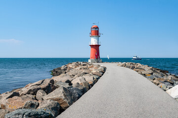 Lighthouse Ostmole Warnemünde near the Baltic Sea, Rostock, Mecklenburg-Vorpommern, Germany - obrazy, fototapety, plakaty