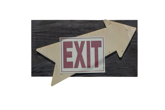Faded EXIT sign with arrow mounted on weathered wood block.
