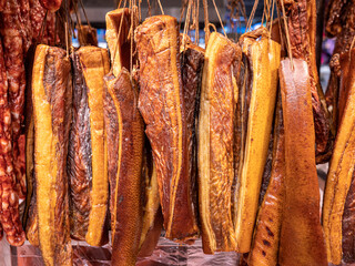 Bacon and sausages hanging in a deli