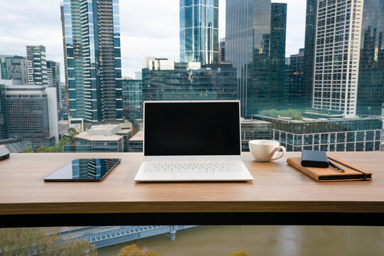 Office desk, out focus city skyline background