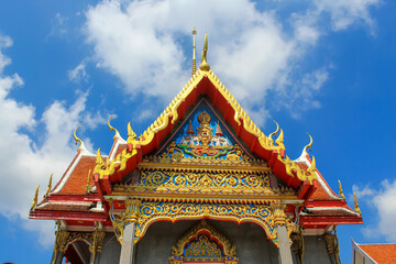 Fototapeta premium Entrance decoration of the Thai buddhist temple in Phuket, Thailand. Blue sky, copy space for text, wallpaper, golden, red, green, blue, background