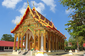 Thai buddhist temple in Phuket, Thailand. Blue sky, copy space for text, wallpaper, golden, red, green