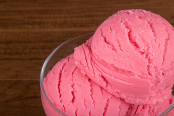 Strawberry flavored ice cream served in a glass bowl. Gourmet photography of Fruit Gelato.
