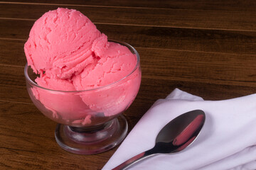 Tasty Strawberry-flavored ice cream served in a glass bowl.