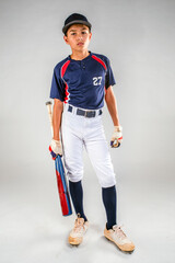 Male youth baseball player standing ready with his bat